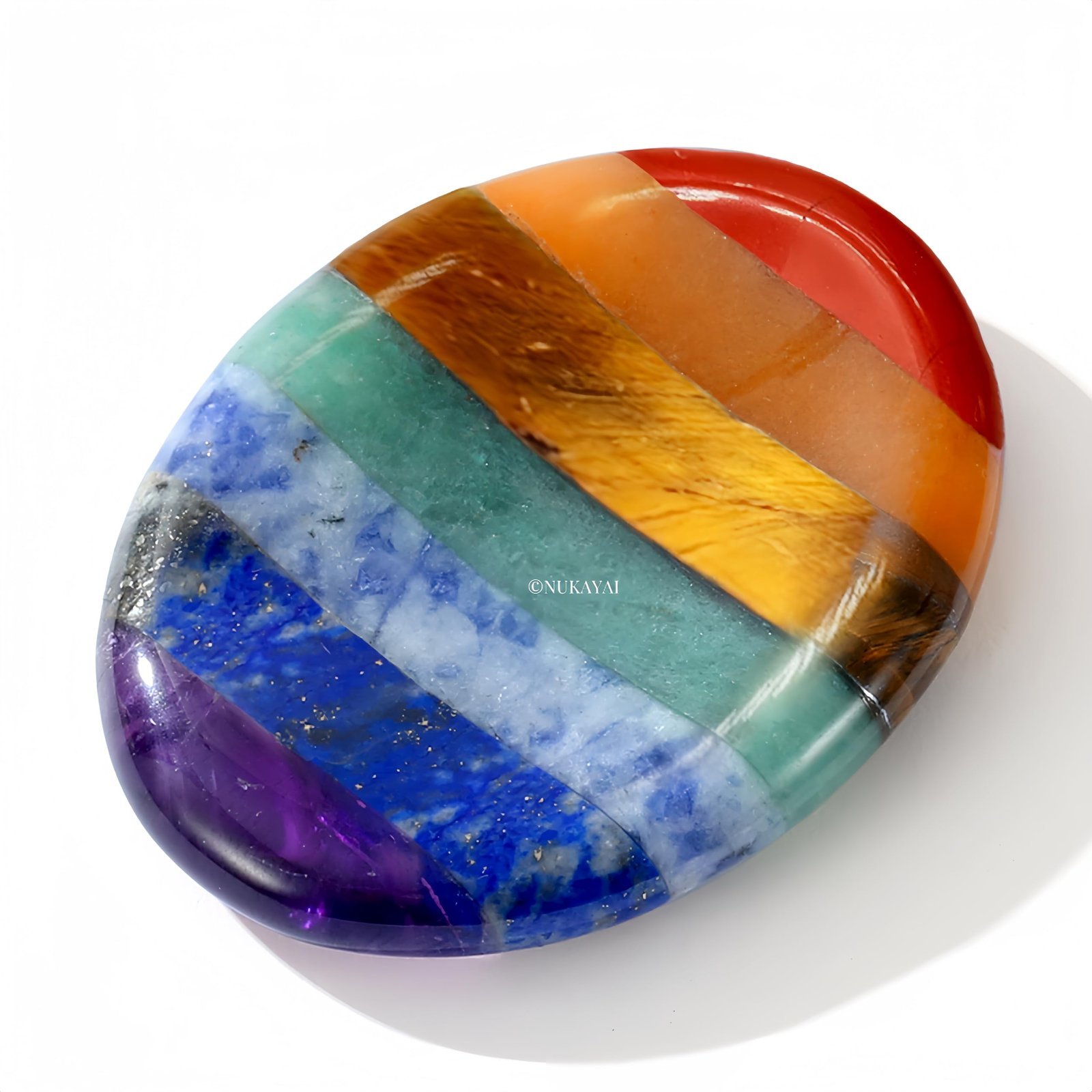 Oval chakra stone with bands of various colors, on a white background